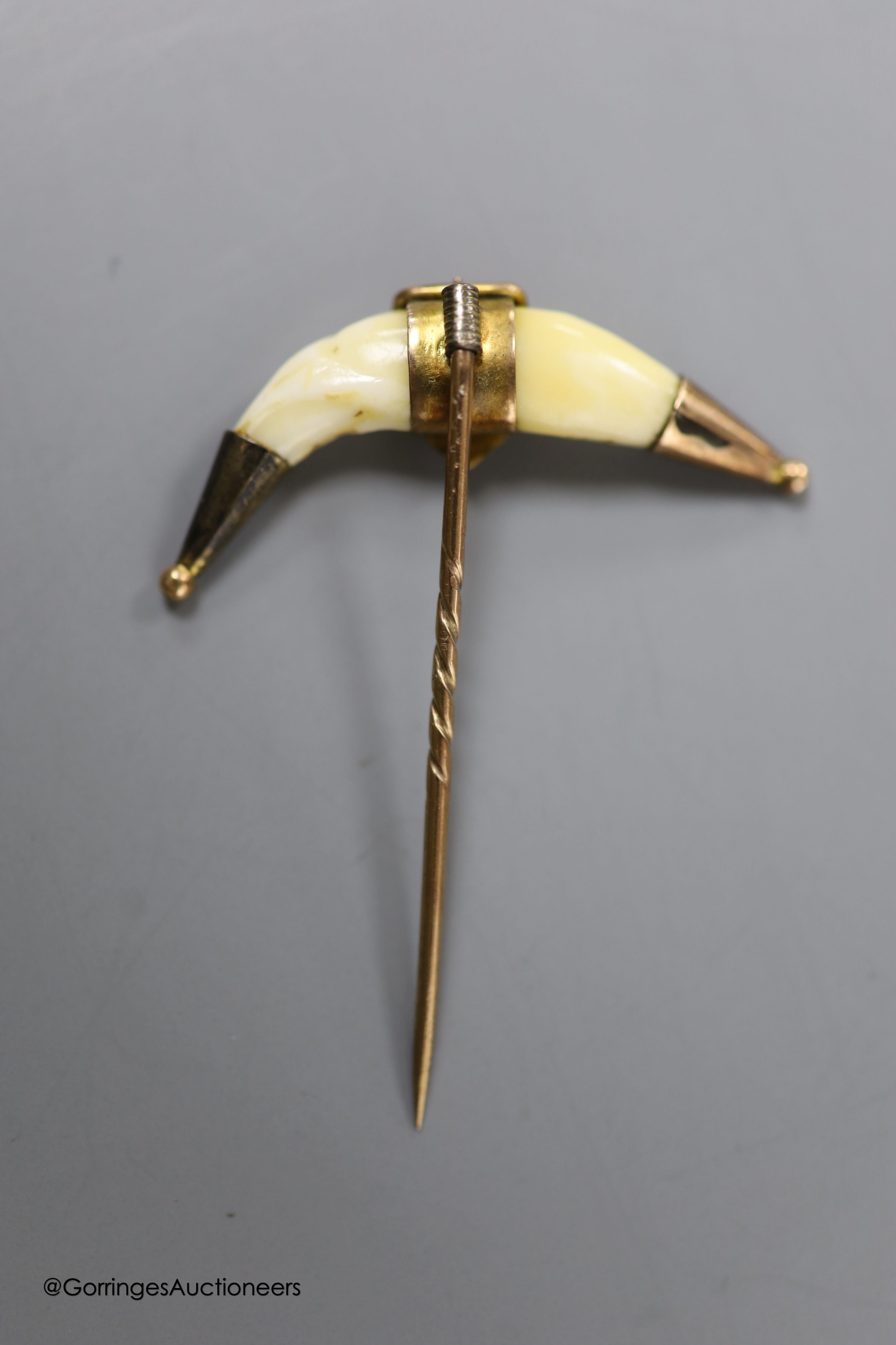 A Victorian yellow metal mounted glazed oval pendant, with miniature portrait of a young lady and plaited hair verso, 40mm, gross weight 18.1 grams, a yellow metal and tooth mounted stick pin and a gem set white metal cl